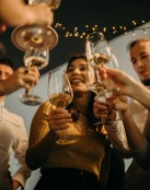 a group of people holding wine glasses