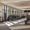 fitness area with treadmills and ceiling lighting